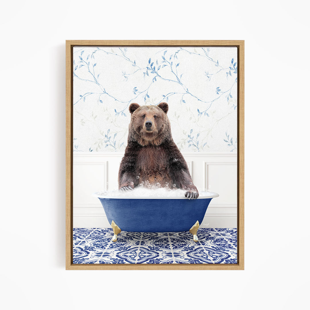 A brown bear sitting in a blue bathtub filled with water, surrounded by a patterned tile floor.