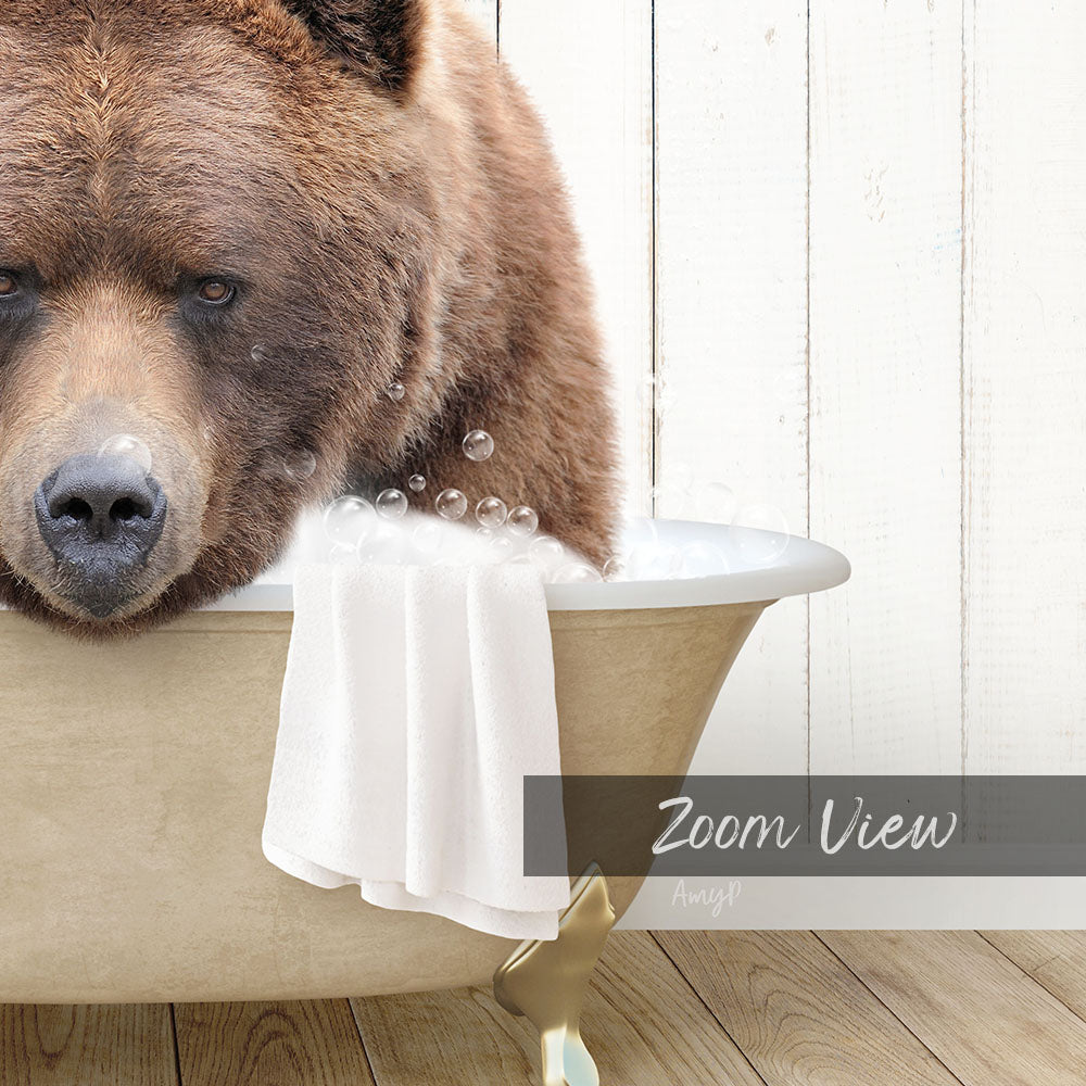 A large brown bear is sitting in a bathtub filled with water, surrounded by bubbles, with a towel draped over the side of the tub.