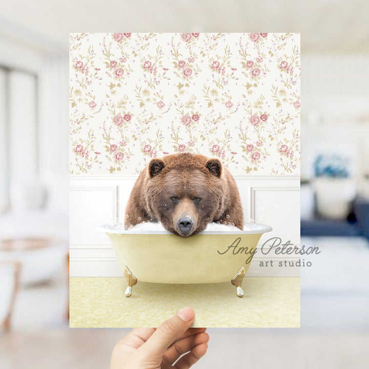 a person holding up a card with a bear in a bathtub