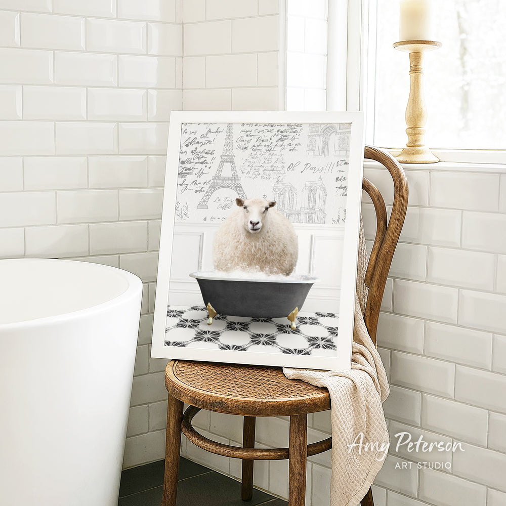 A framed image of a sheep sitting in a bathtub, with a tiled wall and a window in the background.