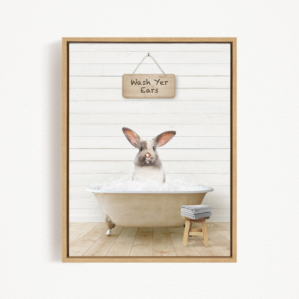 A white rabbit sitting in a bathtub, with a wooden sign above that says "Wash Your Ears".