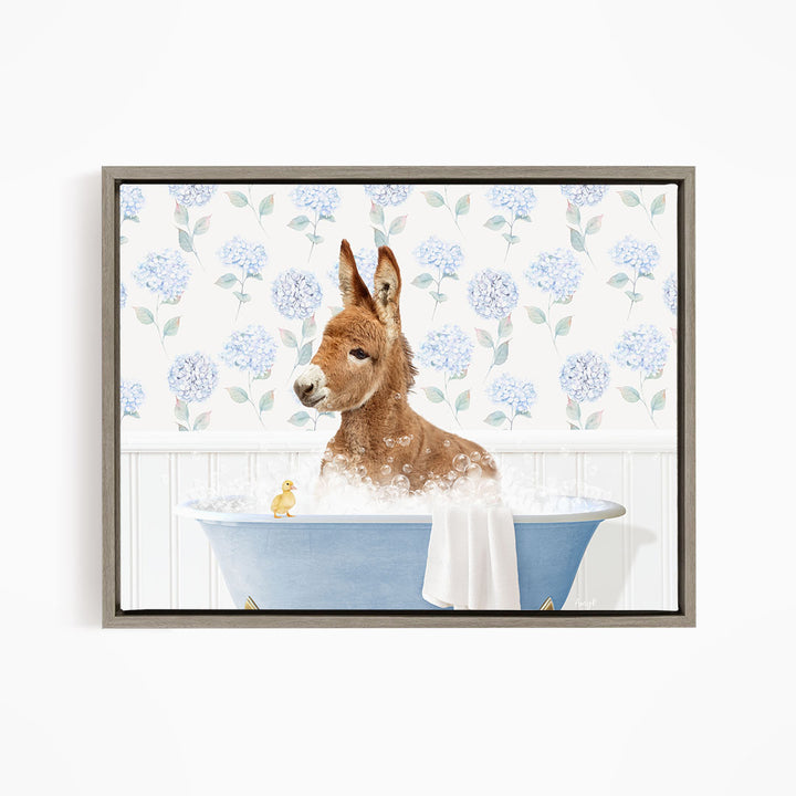 A brown donkey is sitting in a blue bathtub filled with bubbles, surrounded by a floral patterned wall.