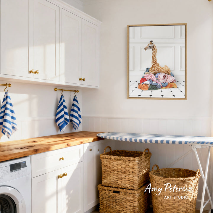 a well-organized laundry room with white cabinets, a wooden countertop, and a framed artwork of a giraffe on the wall.