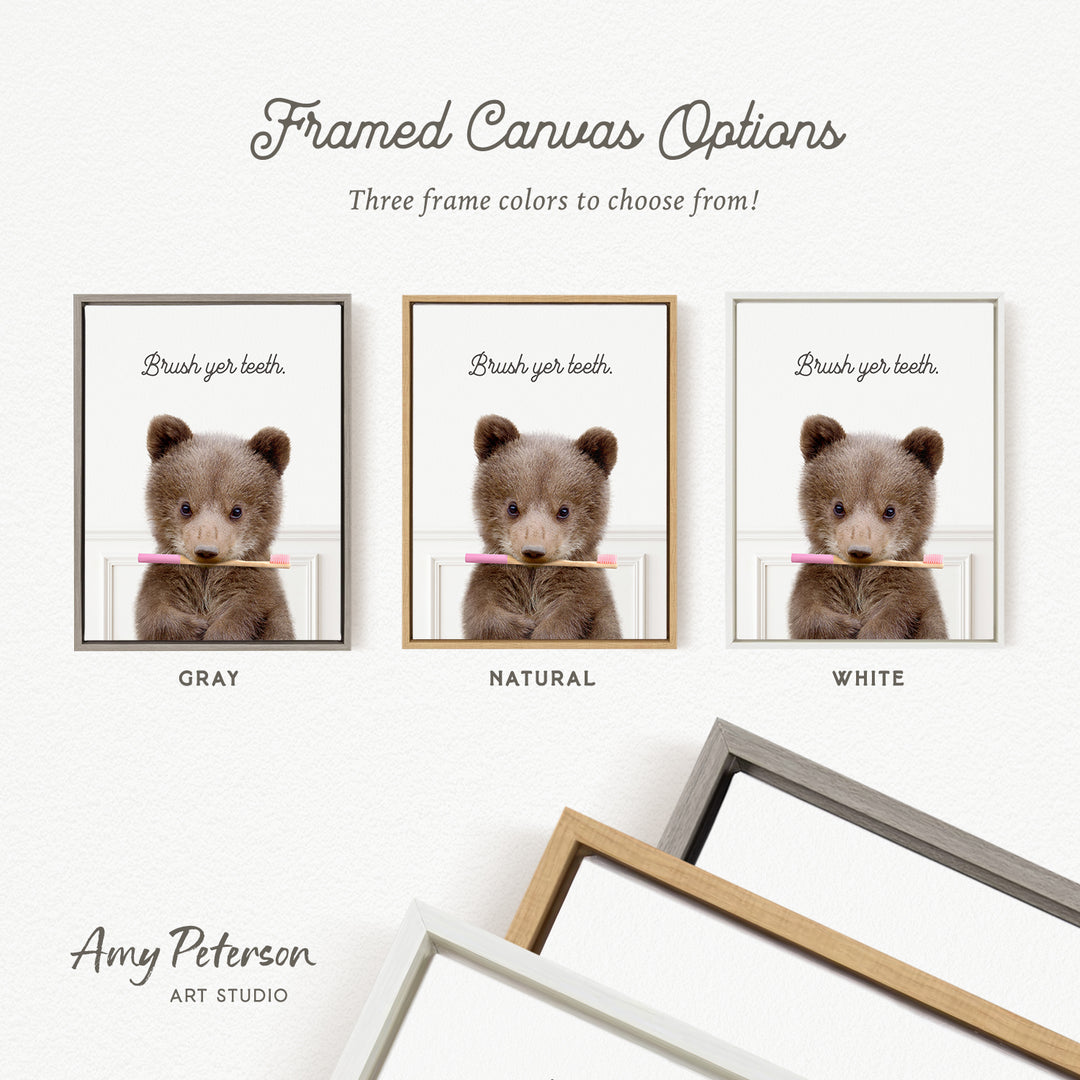 three framed canvas options, each featuring a cute brown teddy bear holding a toothbrush. The options include a gray frame, a natural frame, and a white frame.