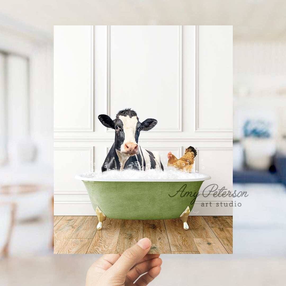 a hand holding up a card with a picture of a cow in a bathtub