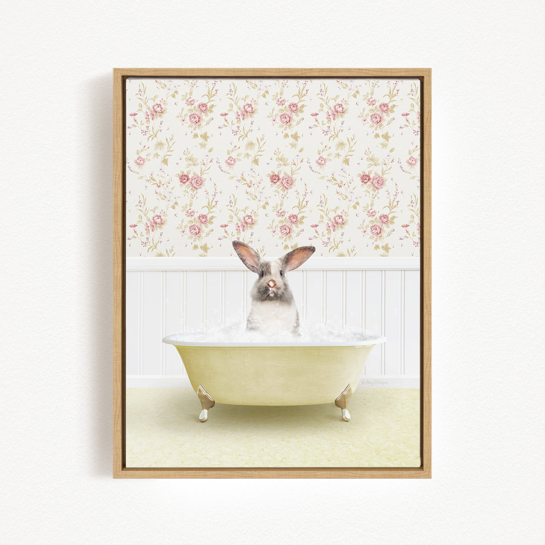 A small rabbit sitting in a yellow bathtub filled with water, surrounded by a floral wallpaper.