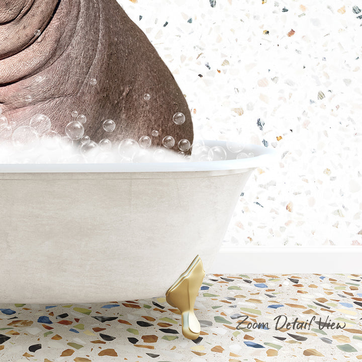 A bathtub filled with bubbles, with a gold-colored bathtub faucet and a mosaic floor in the background.
