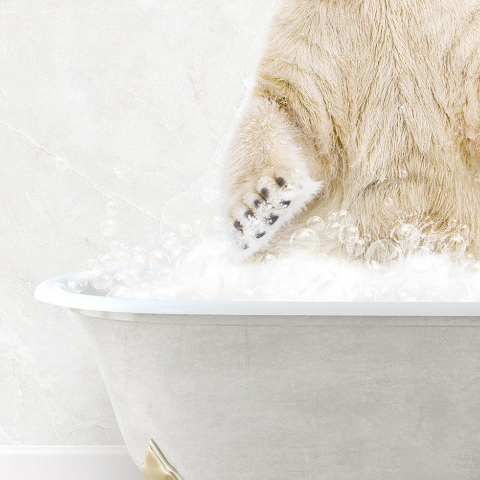 a polar bear sitting in a bathtub full of foam