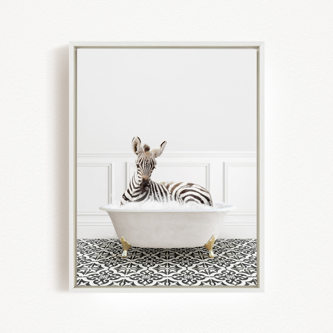 A zebra is sitting in a white bathtub, surrounded by a black and white patterned floor.