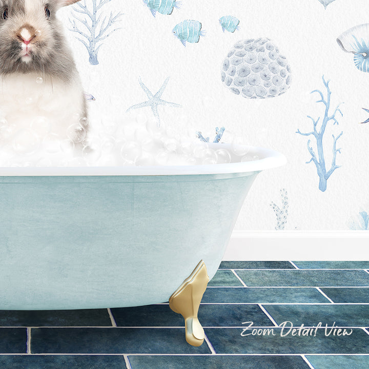 A small rabbit sitting in a bathtub filled with bubbles, surrounded by a blue and white ocean-themed wallpaper.