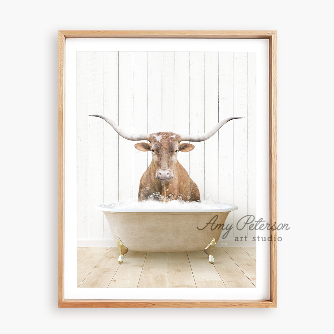 a cow with long horns sitting in a bathtub