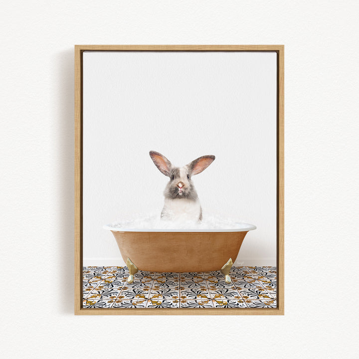 A white rabbit sitting in a bathtub filled with water, looking directly at the camera.