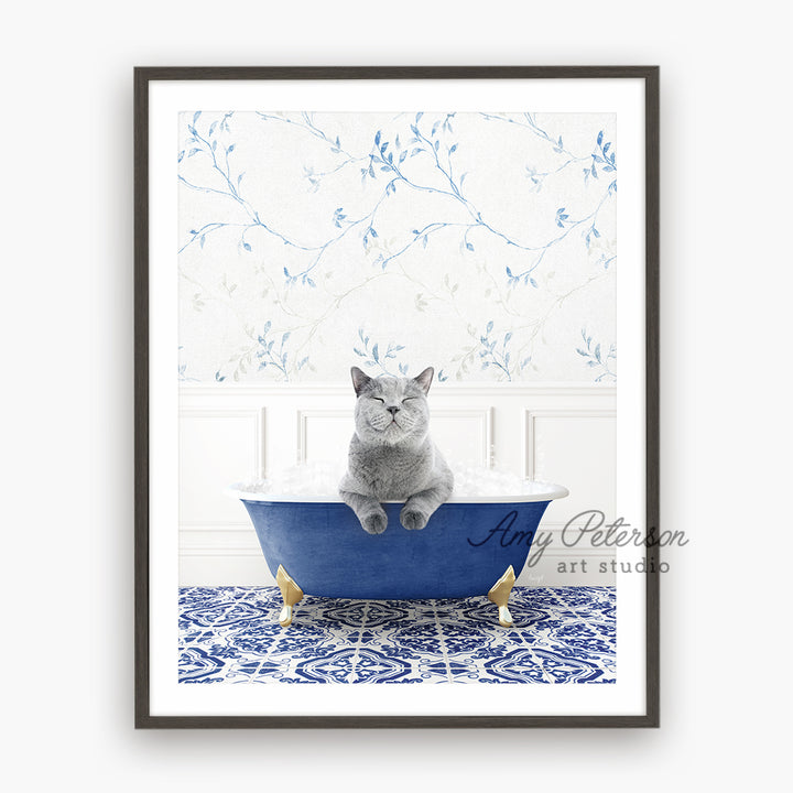 a gray cat sitting in a blue bath tub