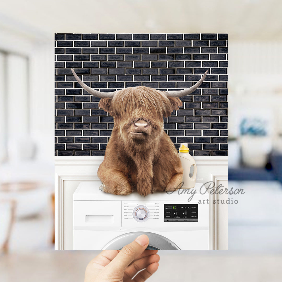 a hand holding a photo of a brown cow