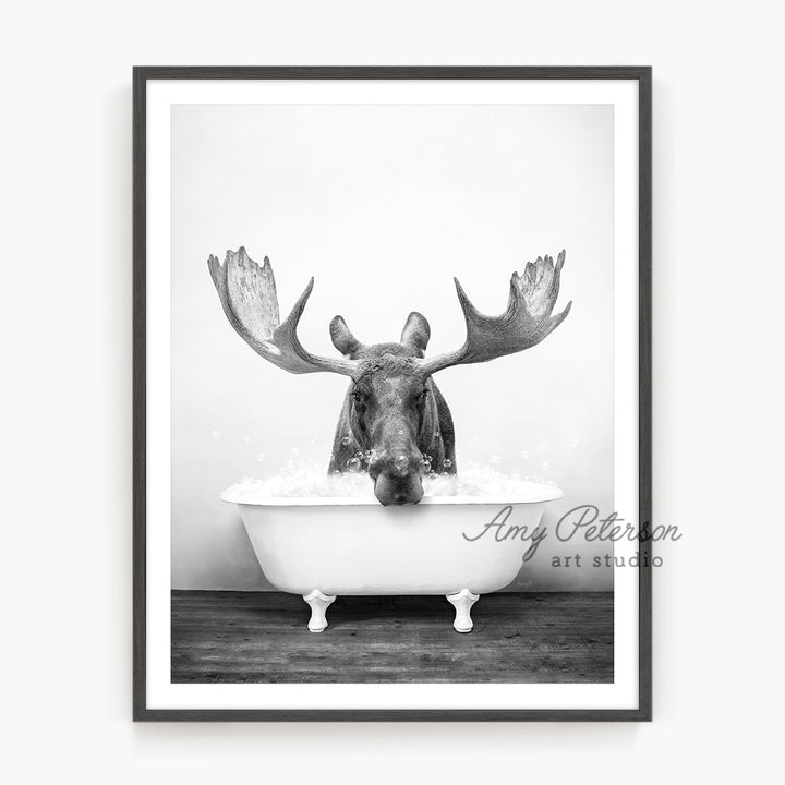 a black and white photo of a moose in a bathtub