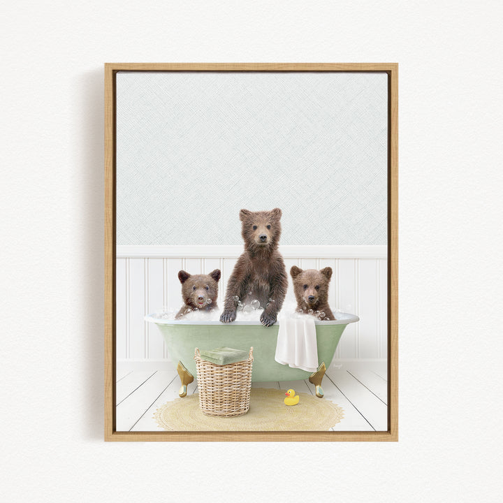A framed image depicting three brown bears sitting in a green bathtub, with a basket of bath toys and a yellow rubber duck nearby.