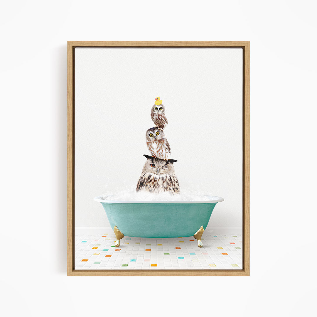 A framed image depicting three owls sitting in a green bathtub filled with bubbles, with one of the owls wearing a yellow hat.