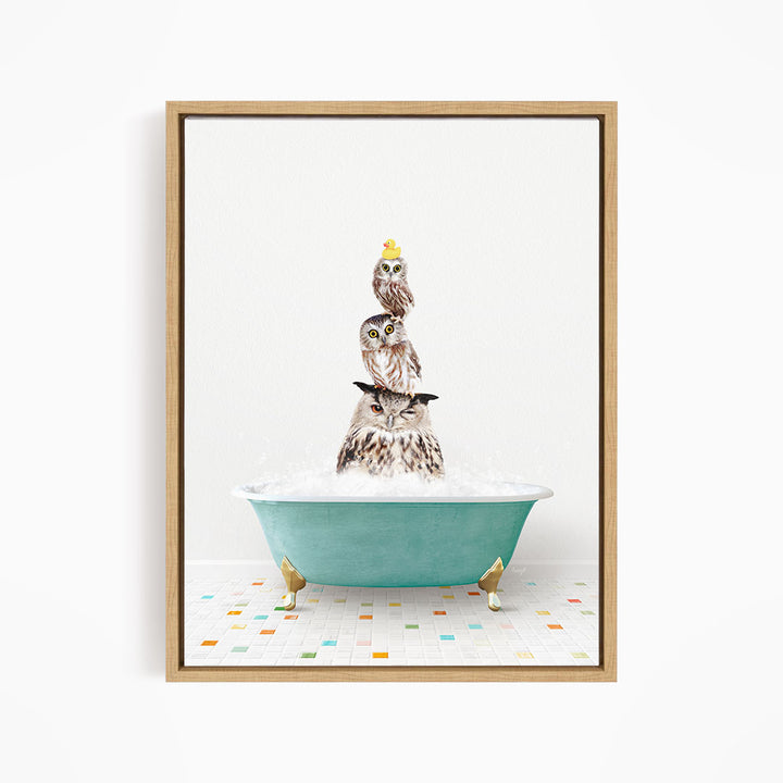 A framed image depicting three owls sitting in a green bathtub filled with bubbles, with one of the owls wearing a yellow hat.