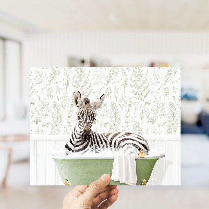A zebra lying in a green bathtub with a towel, surrounded by a patterned wall.