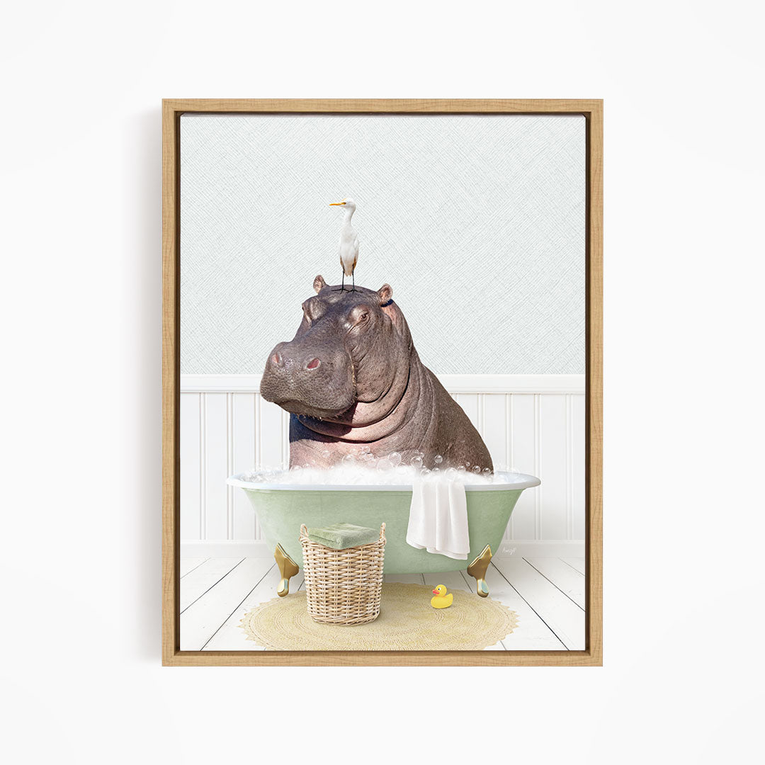 A framed image depicting a hippopotamus sitting in a bathtub, with a bird perched on its head.
