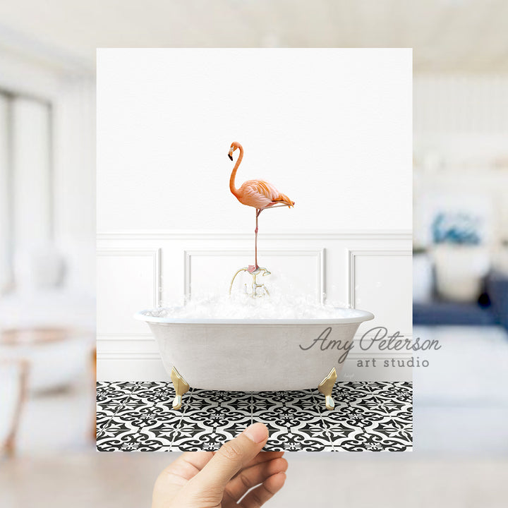 a person holding a card with a flamingo in a bathtub