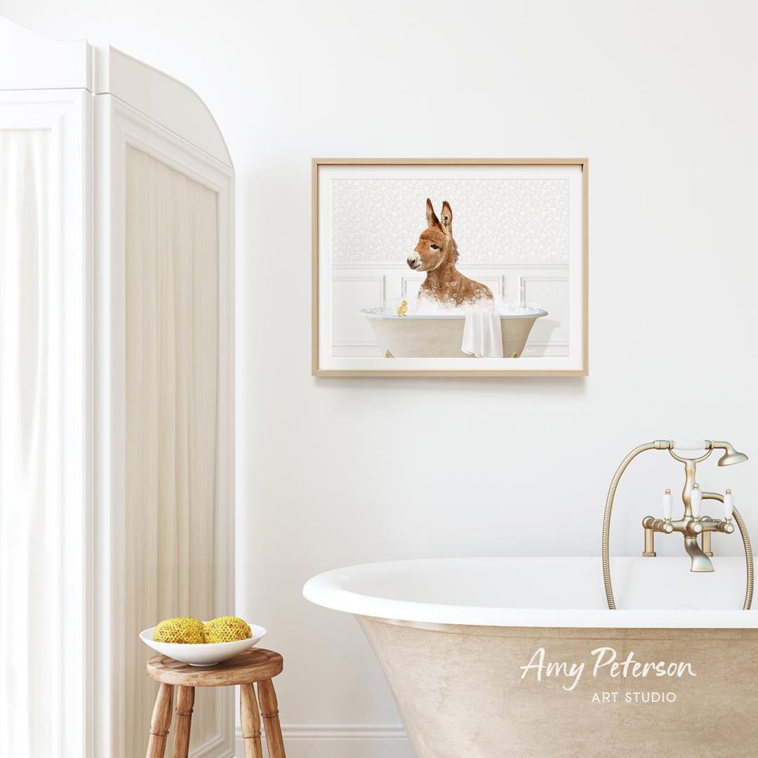 a bathroom with a bathtub, a wooden stool, and a framed picture of a dog sitting in a bathtub.