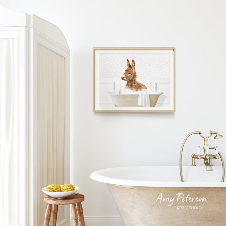 a bathroom with a bathtub, a wooden stool, and a framed picture of a dog sitting in a bathtub.