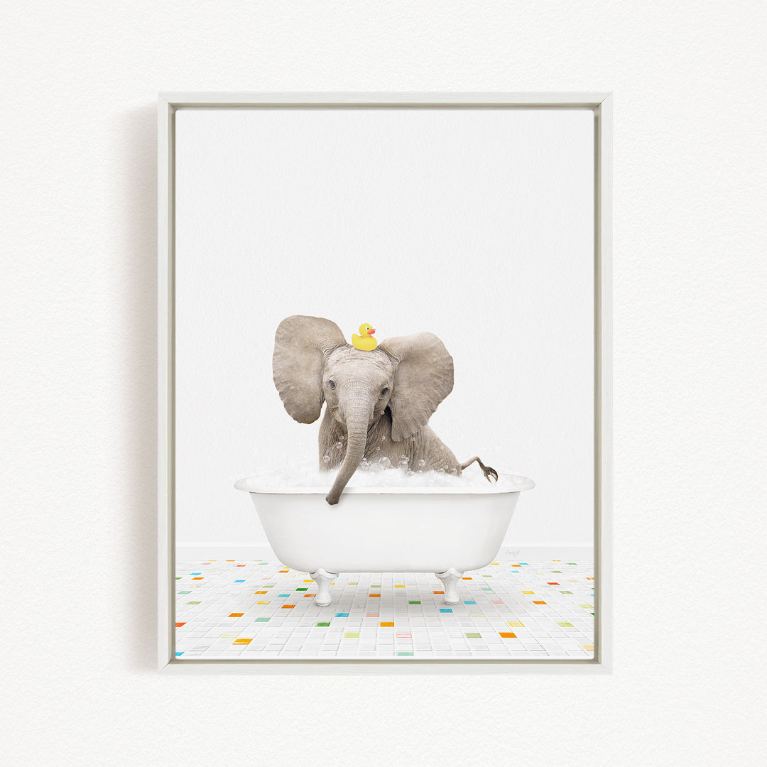 A gray elephant is sitting in a white bathtub filled with water, with a yellow rubber duck floating on its head.
