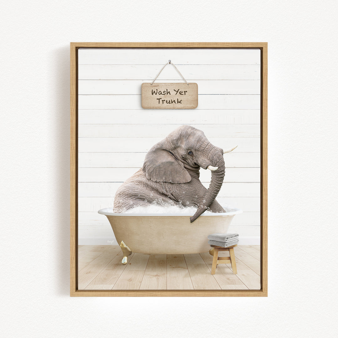 A gray elephant sitting in a bathtub, with a sign above it that says "Wash Yer Trunk".