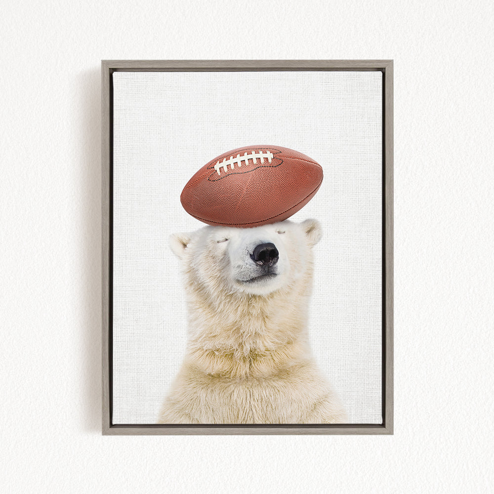 A polar bear balancing a football on its head.