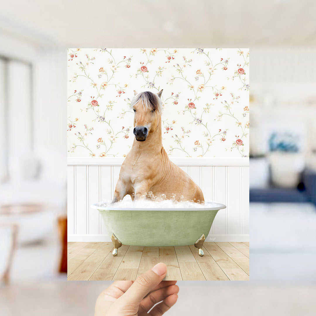 A brown horse sitting in a green bathtub filled with water, surrounded by a floral wallpaper.