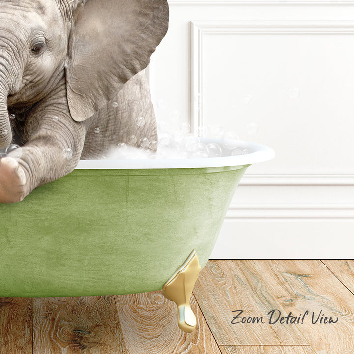A baby elephant sitting in a green bathtub filled with bubbles, with a wooden floor and a white wall in the background.