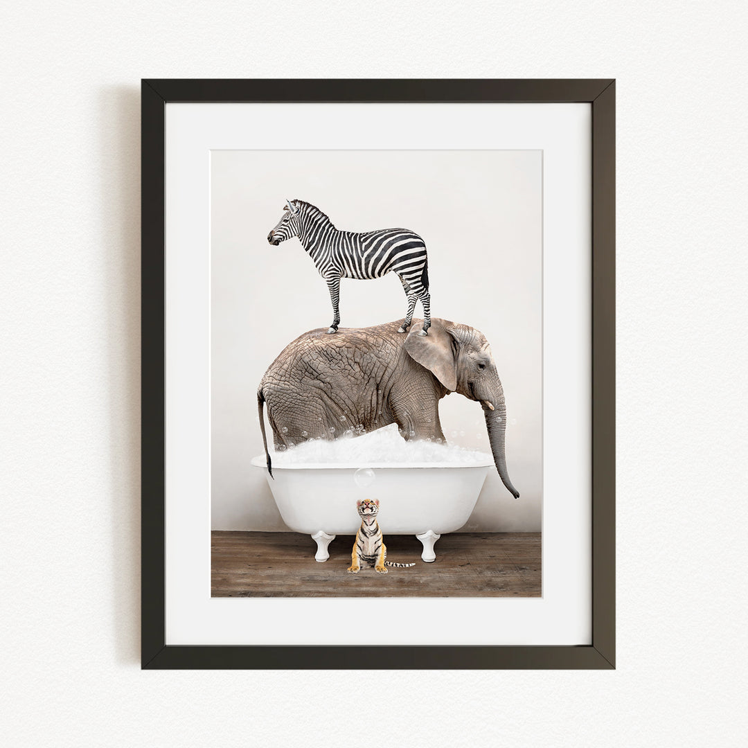 A zebra stands on top of an elephant in a bathtub, with a small tiger sitting in the tub below.