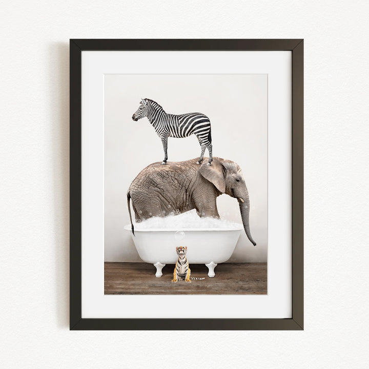 A zebra stands on top of an elephant in a bathtub, with a small tiger sitting in the tub below.