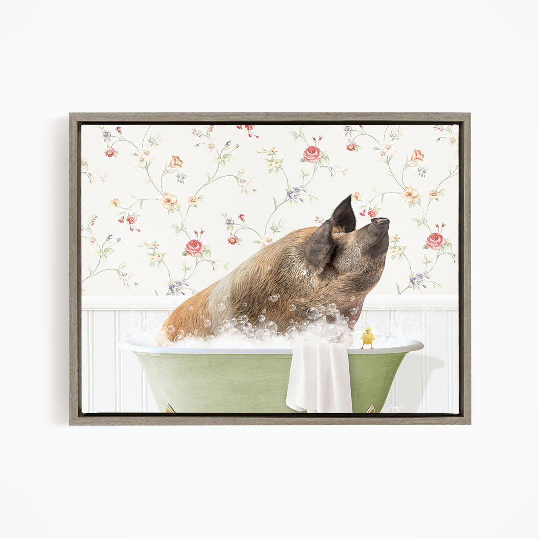 A brown pig sitting in a green bathtub filled with bubbles, with a yellow duck nearby, against a floral wallpaper background.