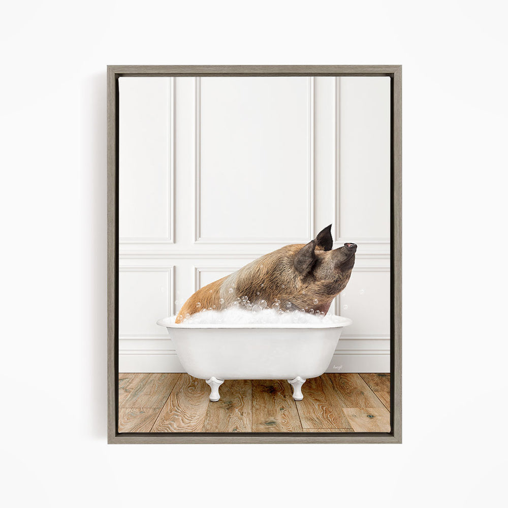 A brown and white pig sitting in a white bathtub filled with bubbles, looking up at the camera.
