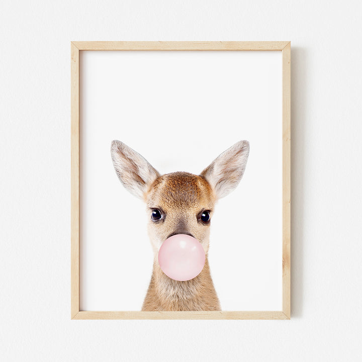 a picture of a deer with a bubble gum in its mouth