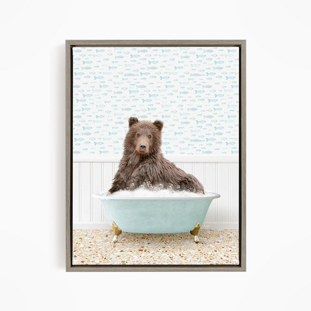 A brown bear sitting in a blue bathtub filled with bubbles, surrounded by a pattern of fish.