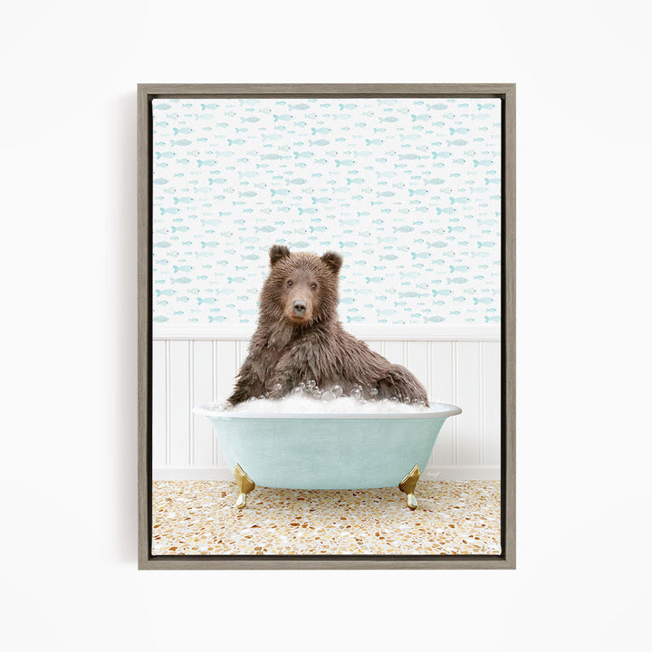 A brown bear sitting in a blue bathtub filled with bubbles, surrounded by a pattern of fish.