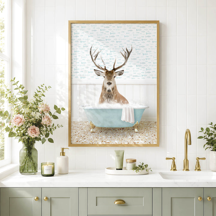 a bathroom scene with a framed picture of a deer sitting in a bathtub, surrounded by flowers and a green vase.