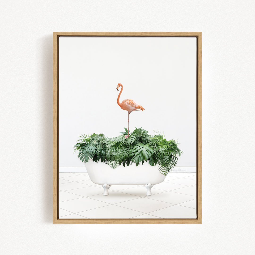A framed image depicting a pink flamingo standing on a white bathtub filled with green plants.