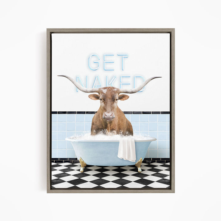 A framed image depicting a bull with large horns sitting in a bathtub, with the text "GET NAKED" displayed above it.