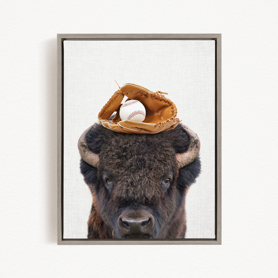 A buffalo with a baseball glove on its head.