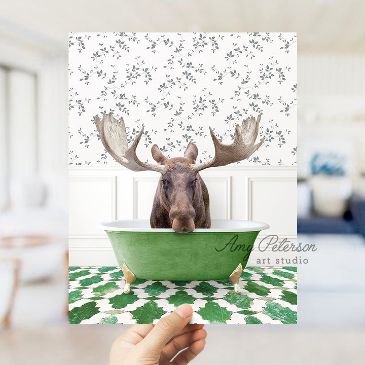 a person holding up a card with a moose in a bathtub