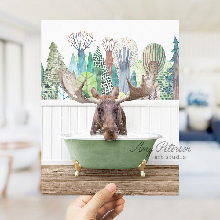 a person holding up a card with a moose in a bathtub