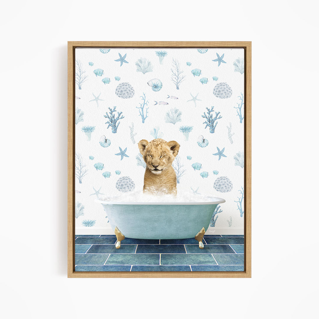 A young lion cub sitting in a blue bathtub filled with water, surrounded by a pattern of seashells, starfish, and other marine life.