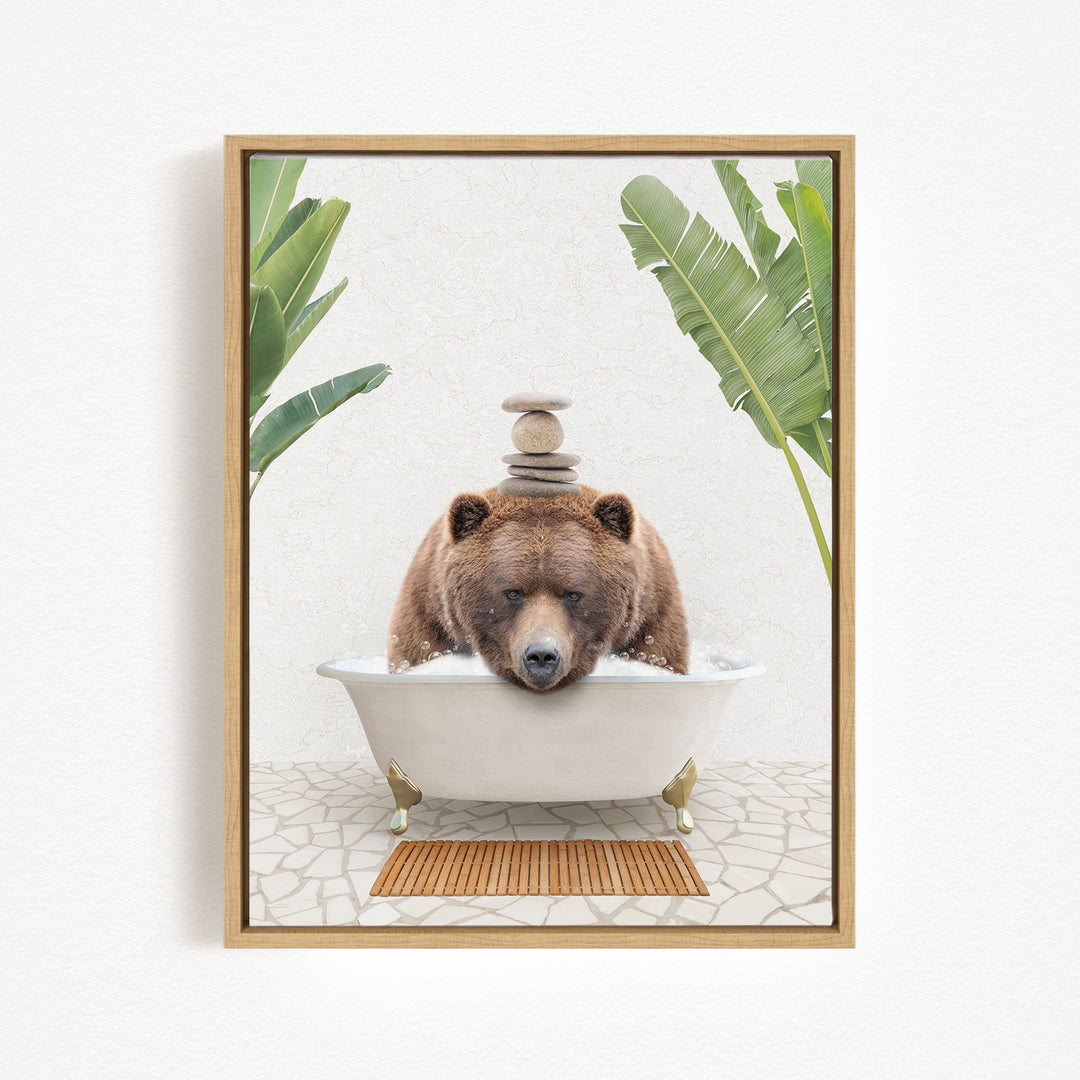 A brown bear is sitting in a white bathtub filled with water, surrounded by green plants and a wooden mat on the floor.