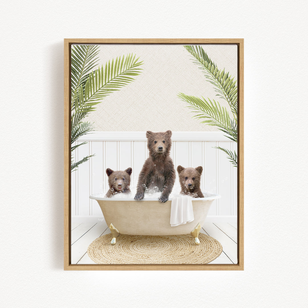 A framed image depicting three bears sitting in a bathtub, surrounded by palm leaves.