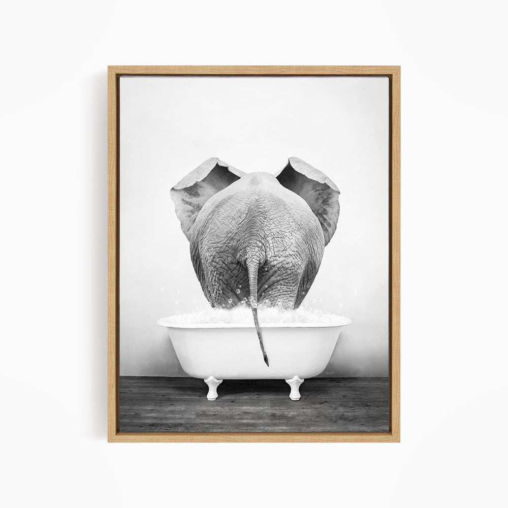 A black and white photograph of an elephant standing in a bathtub filled with water, with its trunk submerged in the water.