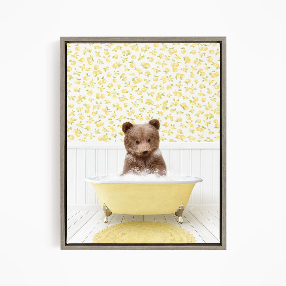 A cute brown bear sitting in a yellow bathtub filled with water, surrounded by a yellow floral wallpaper.